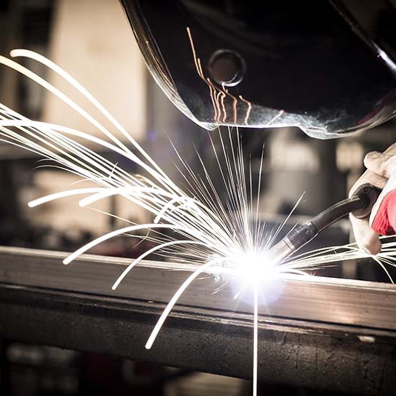 Welder welding materials together