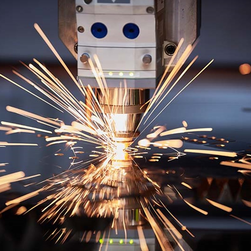 Laser cutter cutting out a piece of material