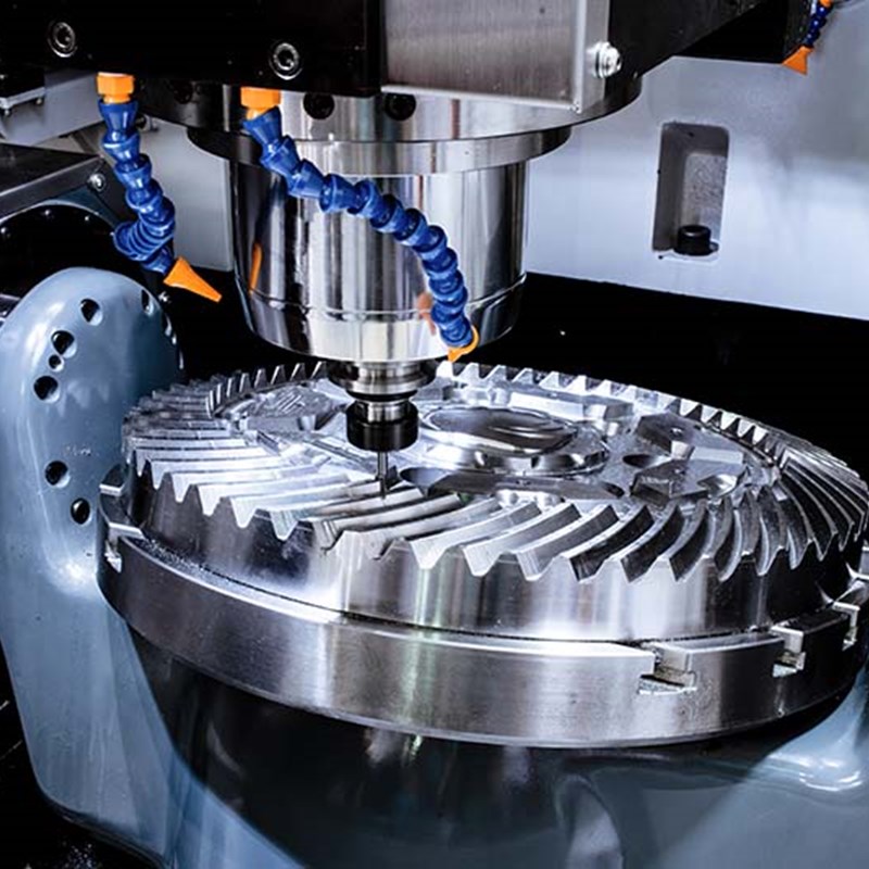 Metal cutting machinery cutting out an intricate gear