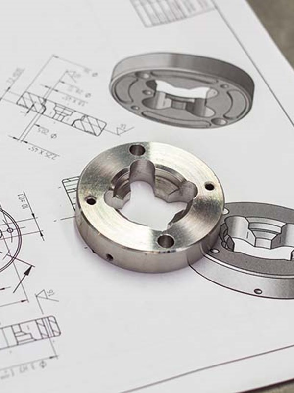 Machined part placed on top of it's blueprint