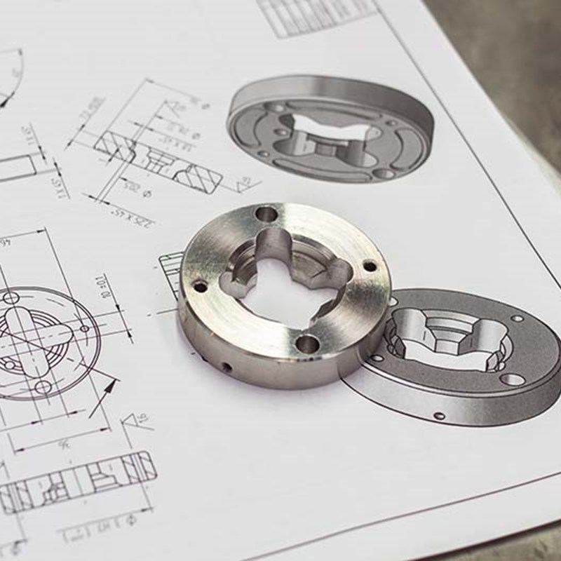Machined part placed on top of it's blueprint