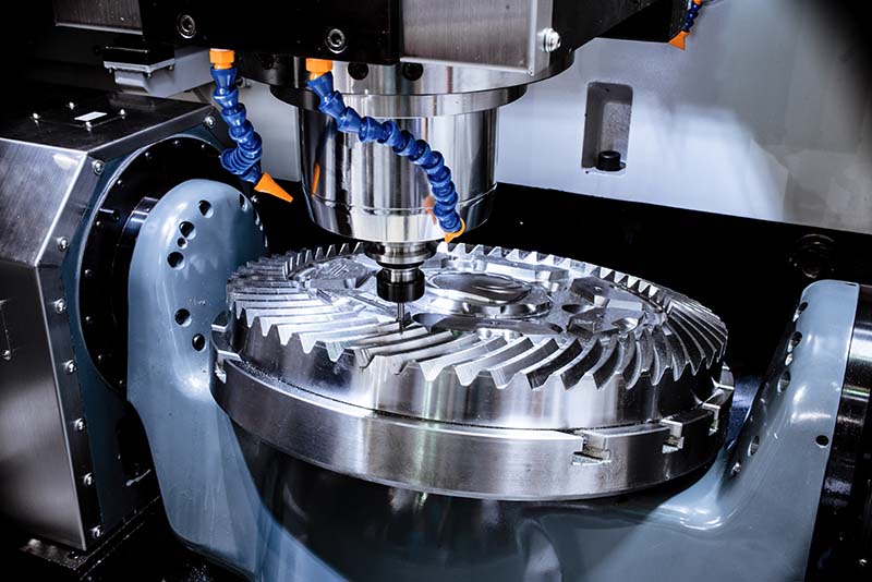 Metal cutting machinery cutting out an intricate gear